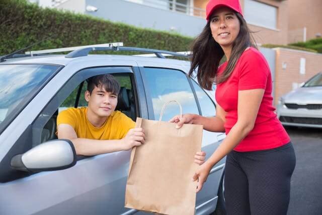 Driver delivering to a customer's car